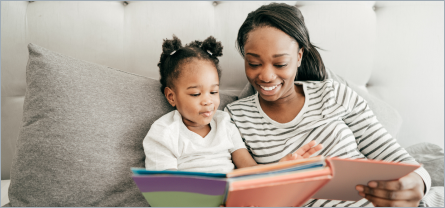 Parent and Child reading a book.